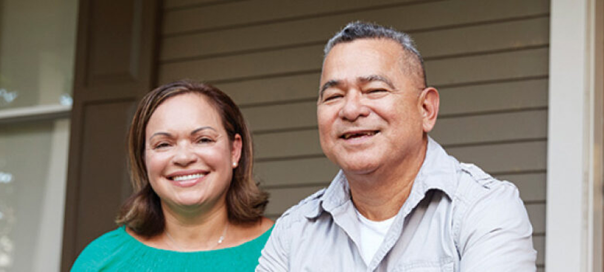 A picture of a man and a woman with smiling faces posing for a photo.