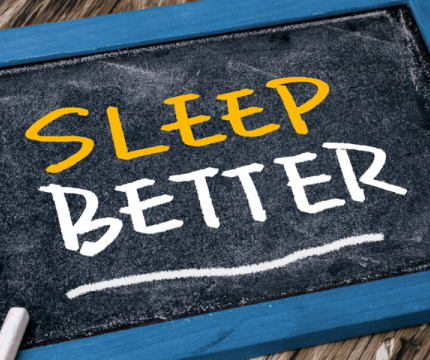 A picture of black bloard with text reading "SLEEP BETTER."
