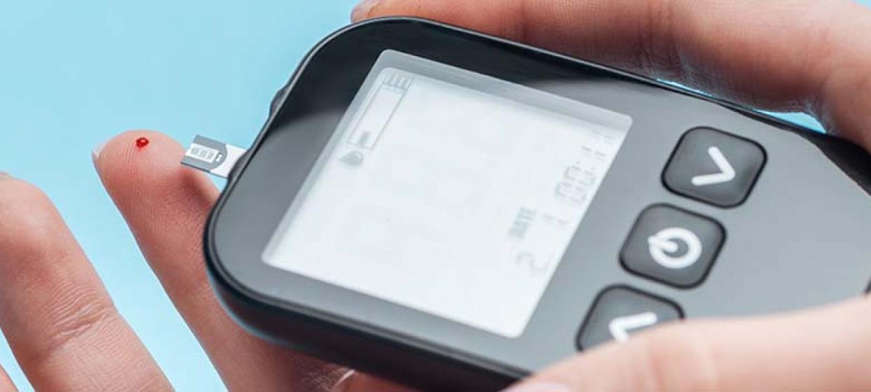 A picture of a hand holding a diabetes monitoring device.